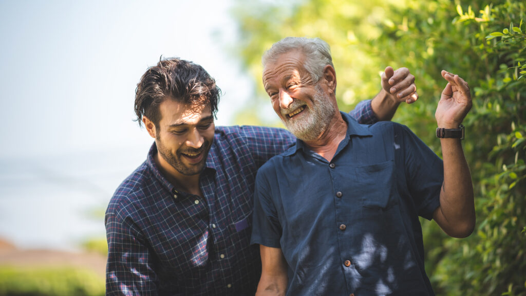 caucasian senior father and adult son are hugging together at home, generation family are happy with people love, male mature, old person man, elderly grandfather smiling living at the house