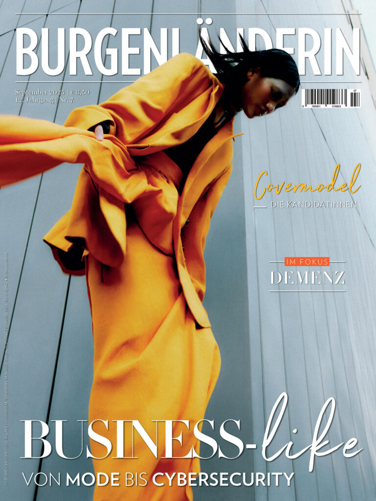 BURGENLAENDERIN: Graues Heftcover mit einer dunkelhäutigen Frau im sonnenblumengelben Hosenanzug darauf