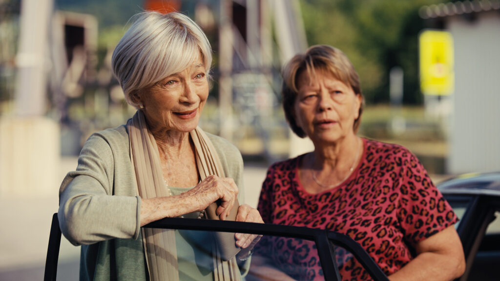 Kultur-Highlights im November: Zwei ältere Frauen im Freien im Gespräch bei sonnigem Wetter