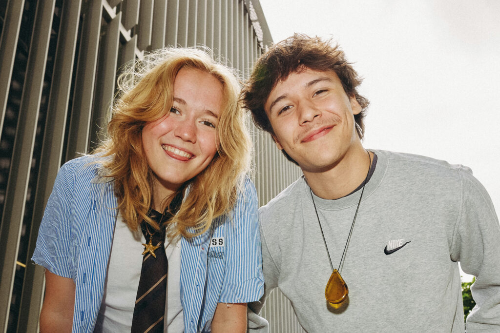 Churro64 und Luisa Schweig bei einem entspannten Outdoor-Porträt mit modernem Streetstyle-Look.