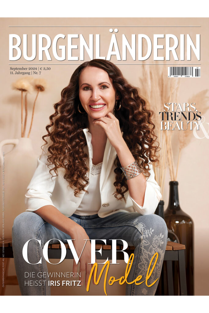Covermodel: Magazincover der BURGENLÄNDERIN mit einer lächelnden Frau mit langen Locken in weißem Blazer und Jeans, Titelthema „Covermodel Iris Fritz“.